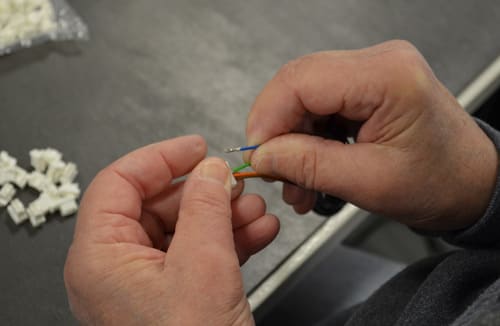 Levison employee working with wiring