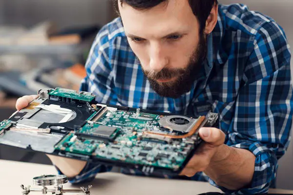 Man examining PCB