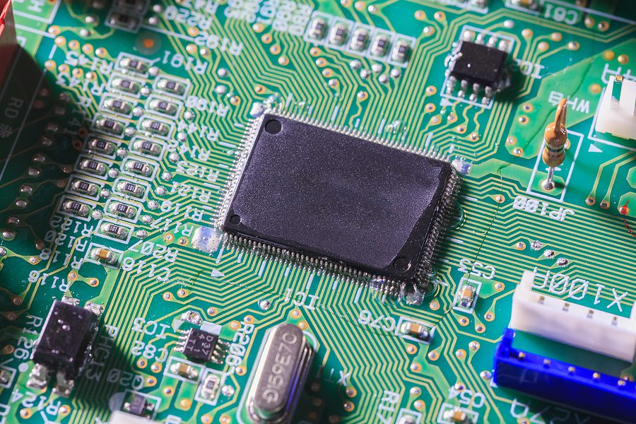 Computer chip on green electronic circuit board or printed circuit board-PCB with electronic components. Technology concept.