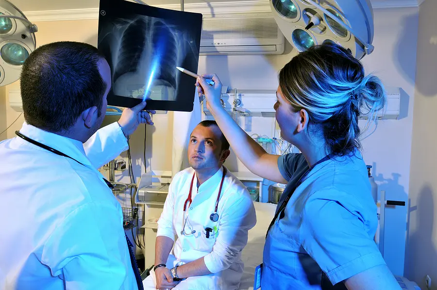 Medical doctors and a nurse looking at x-ray - a series of emergency room photos.