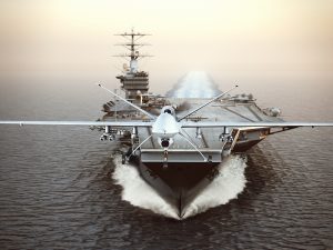 Military drone aircraft launching from an aircraft carrier. 