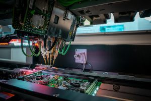 Close up of automated machine in an electronic manufacturing facility. 