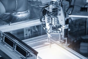 Closeup of a robotic arm used in electronic manufacturing. 