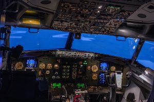 Interior view of a plane's cockpit, focusing on the control panels 