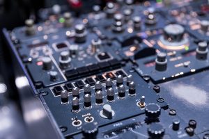 Detailed view of the upper set of control switches in the cockpit of an aircraft.