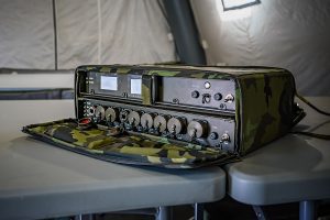Military grade ruggedized ethernet network switch on a desk in an army tent 