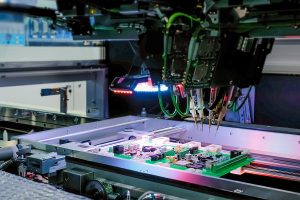 Printed circuit boards being tested on a machine. 