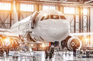 Commercial airplane being worked on by a mechanical engineer